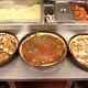 deep dish pizzas being prepared at restaurant